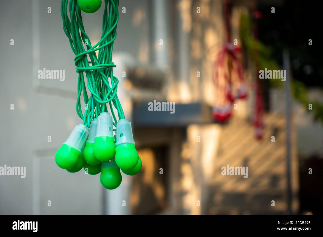 Close-up shot of multicolor led light bulbs hanging off a rooftop in an Indian household during the Deepawali festival. Uttarakhand India. Stock Photo