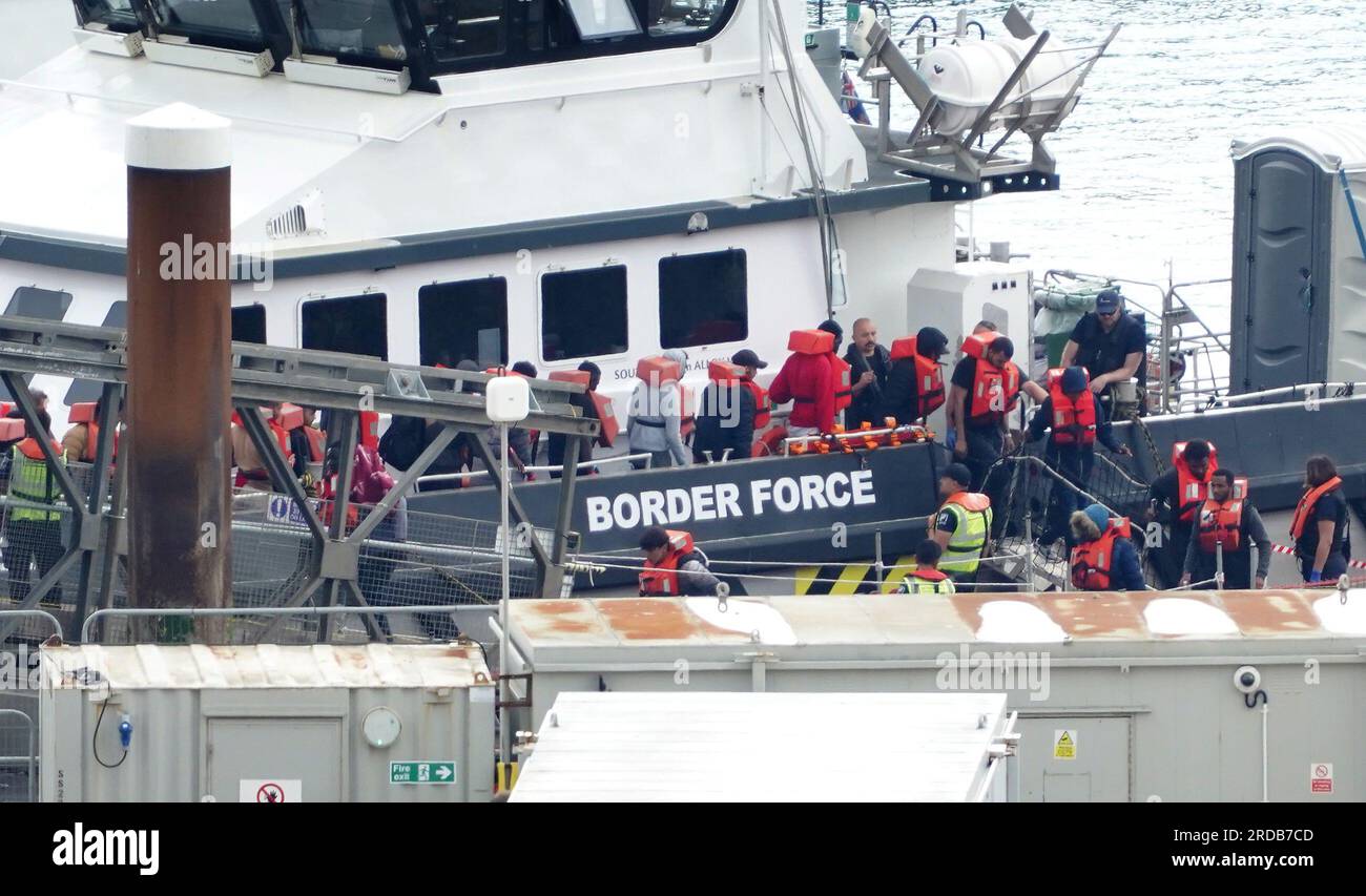 A group of people thought to be migrants are brought in to Dover, Kent ...
