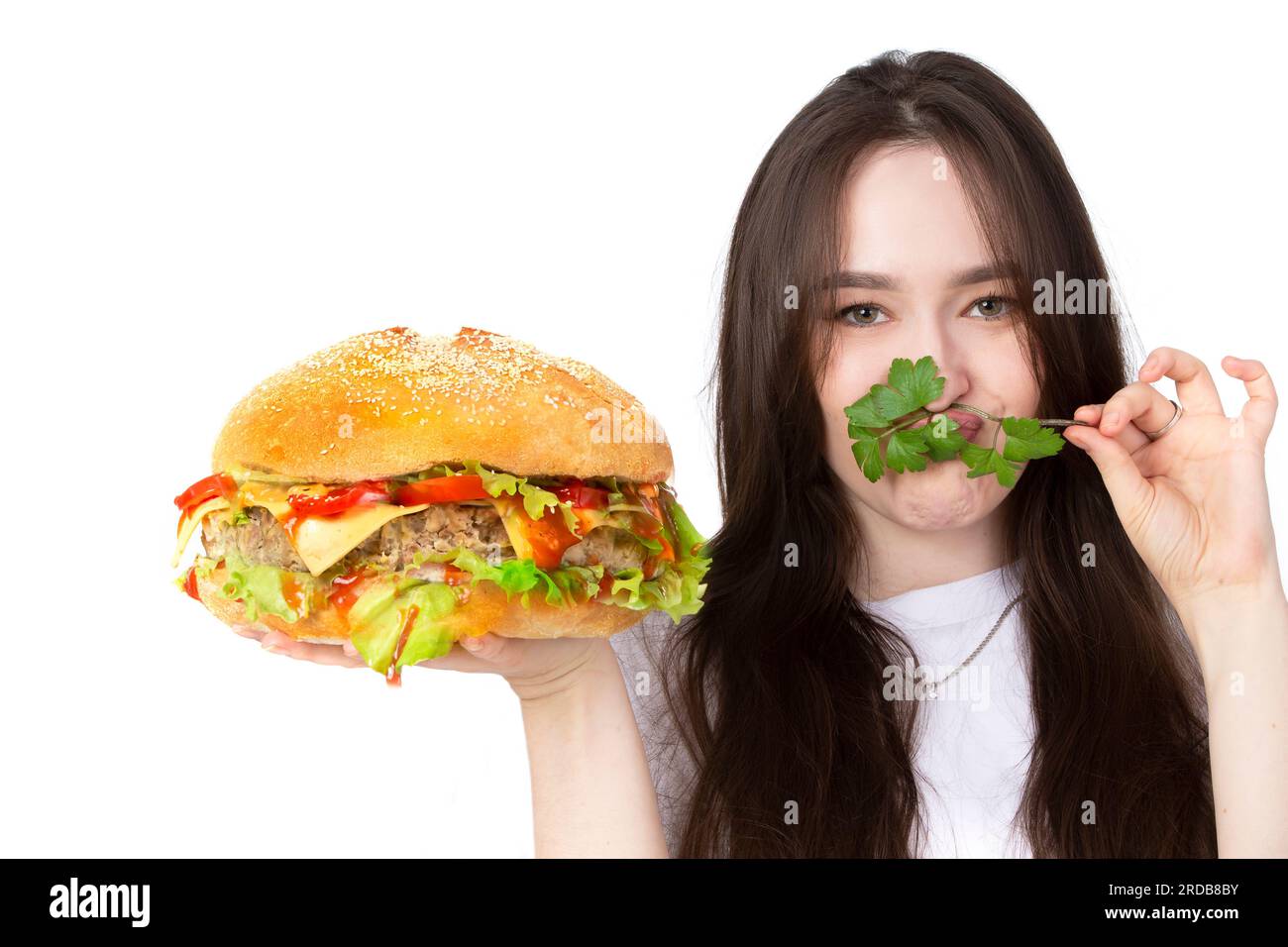 A woman is holding a big barbecue hamburger sandwich on the background ...