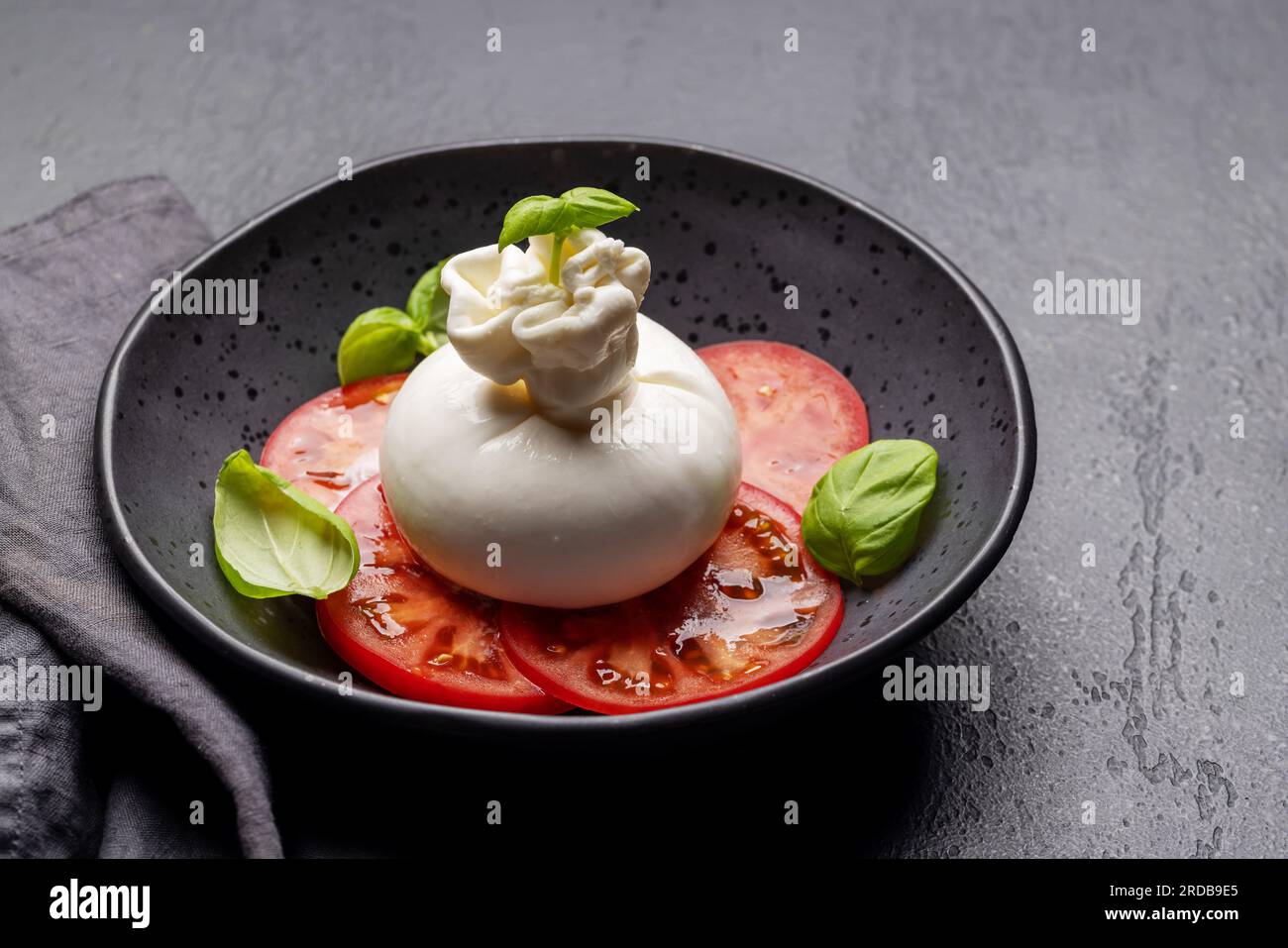 Antipasto with burrata cheese, tomatoes and basil. Italian cuisine