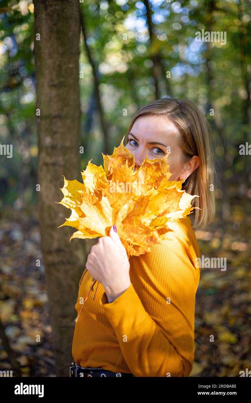 Beautiful woman in autumn park. happiness, harmony, self-care, relaxation and mindfullness. Stock Photo
