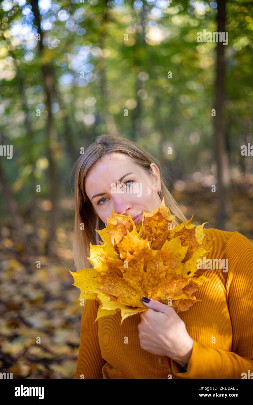 Beautiful woman in autumn park. happiness, harmony, self-care, relaxation and mindfullness. Stock Photo