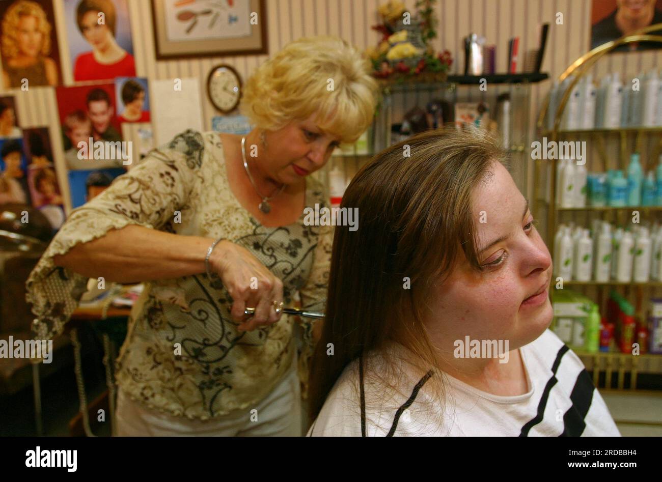 Angie Hale (right) has 13 inches of her hair cut off to donate to the Locks of Love program on Wednesday, July 20, 2005 at The Hair Affair in Russell Springs, Russell County, KY, USA. Established in 1997, Locks of Love is a nonprofit organization that creates prosthetic hairpieces for children suffering from medical hair loss. (Apex MediaWire Photo by Billy Suratt) Stock Photo