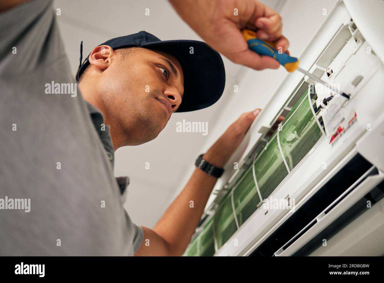 Maintenance, air conditioner and man with screwdriver for problem