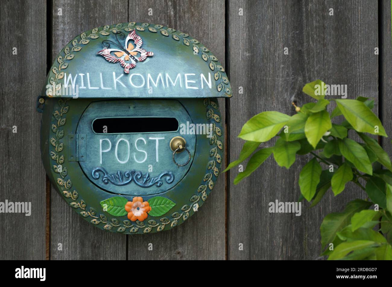 A nicely decorated letterbox on a wooden wall Stock Photo