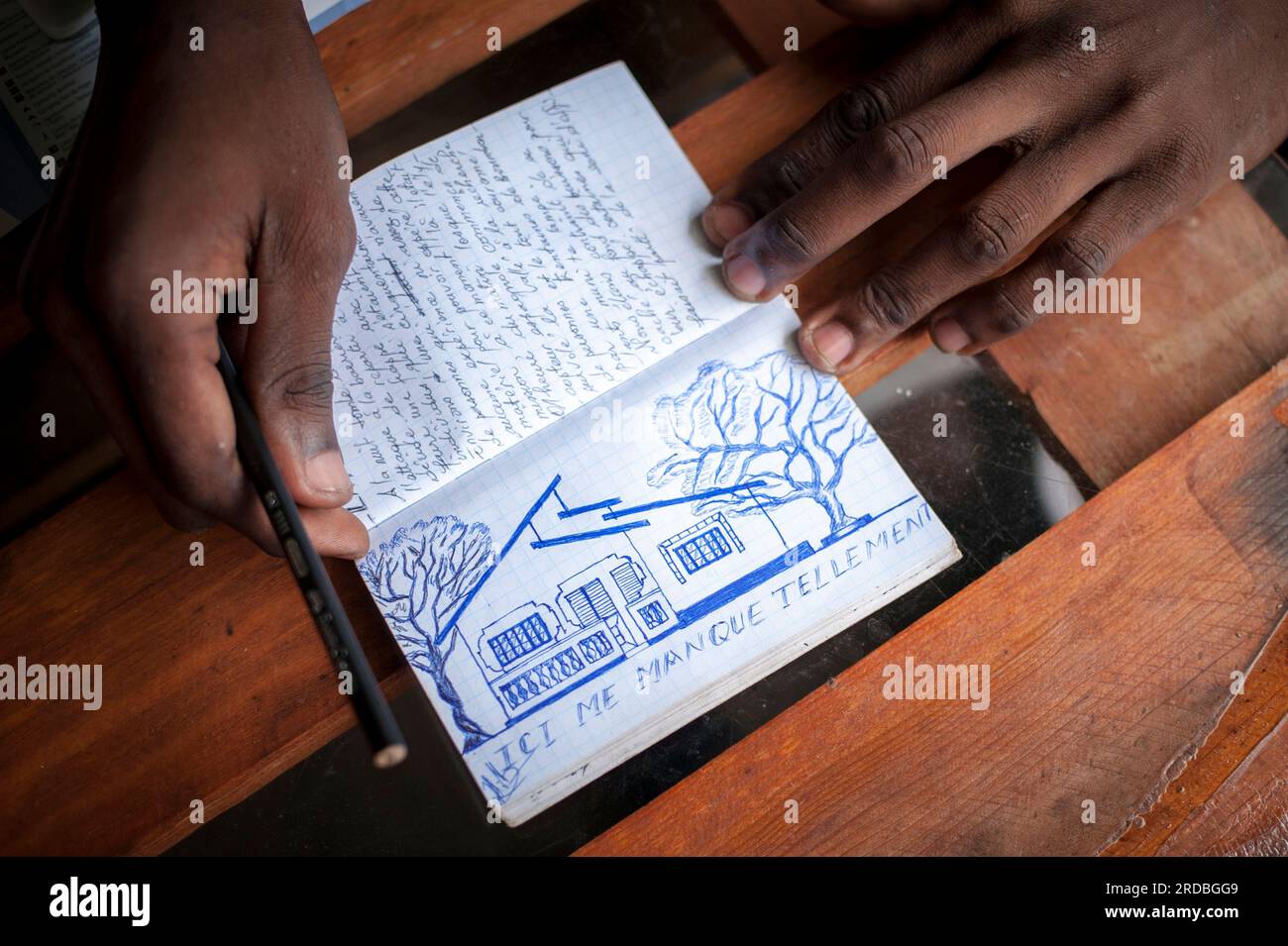 https://c8.alamy.com/comp/2RDBGG9/thats-my-home-in-coyah-says-amdi-as-he-shows-a-notebook-full-of-words-and-drawings-he-did-during-his-long-journey-irun-basque-country-september-4-2018-as-the-number-of-migrants-arriving-on-the-coasts-of-southern-spain-increased-more-and-more-migrants-are-heading-north-to-the-border-city-of-irun-to-try-to-cross-the-border-with-france-and-continue-on-their-way-french-authorities-have-reacted-by-placing-police-controls-at-all-borders-and-causing-many-migrants-to-seek-alternative-route-and-methods-to-cross-the-border-and-to-continue-their-journey-to-other-european-countries-in-irun-t-2RDBGG9.jpg
