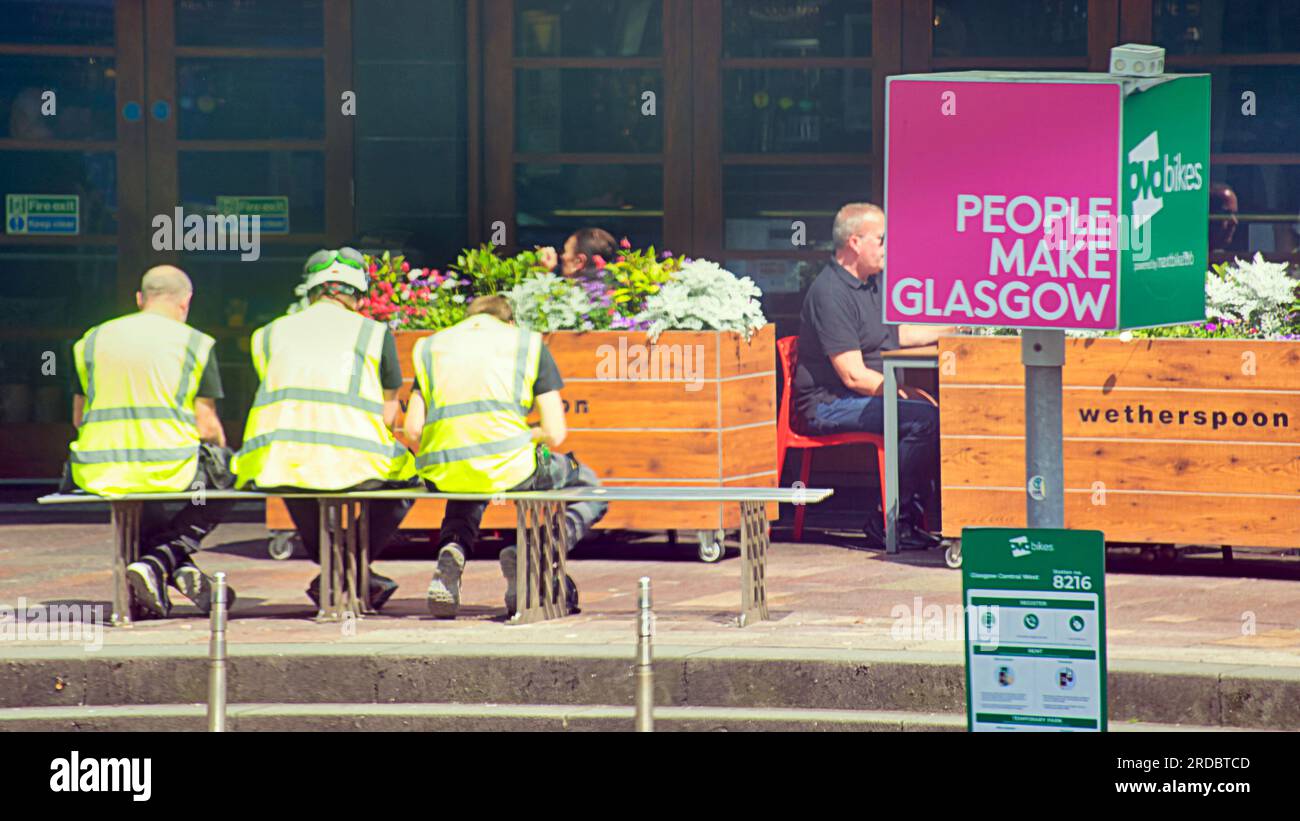 people make glasgow workers in yellow vests Stock Photo