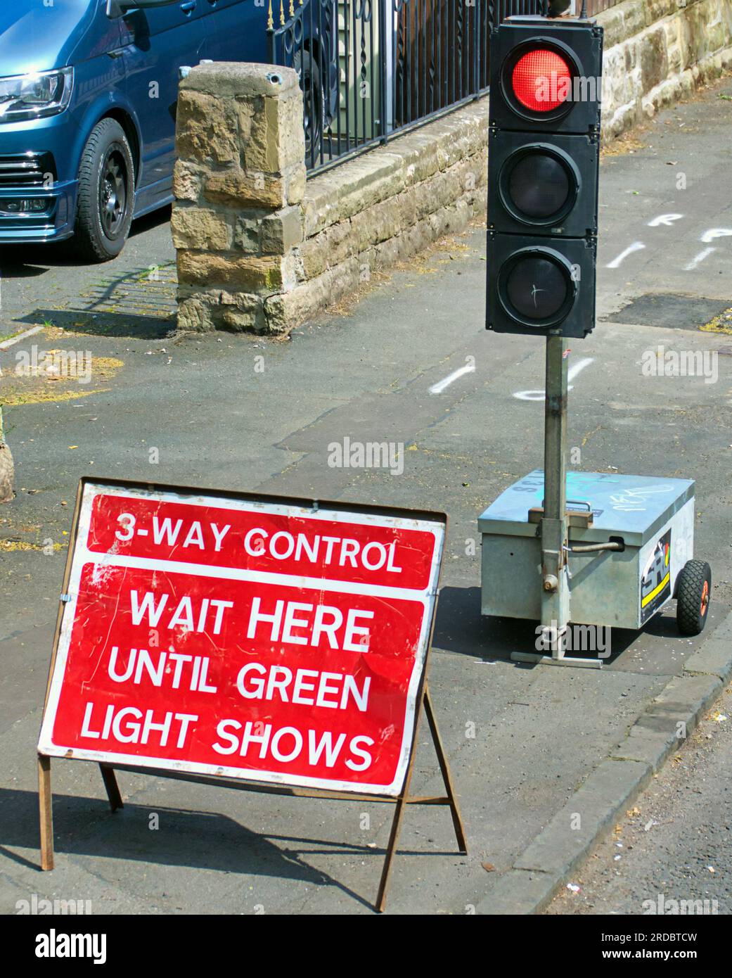 temporary traffic lights wait here until green light shows Stock Photo
