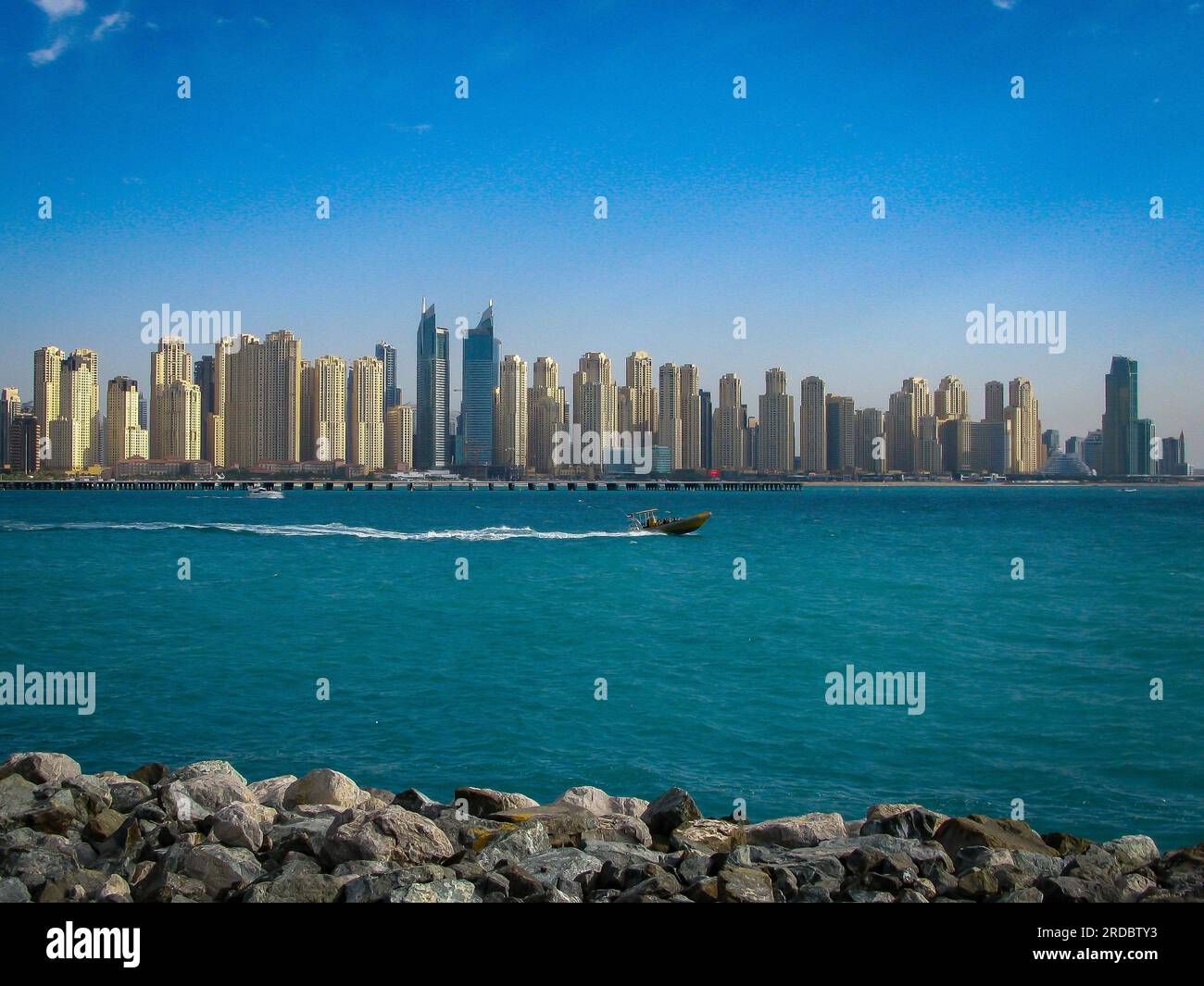 view of the beach and skyscrapers from the promenade of the artificial