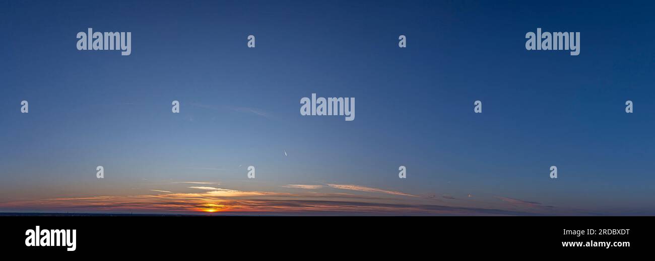 Picture of dramatic and colorful sky with sun during sunset in summer ...
