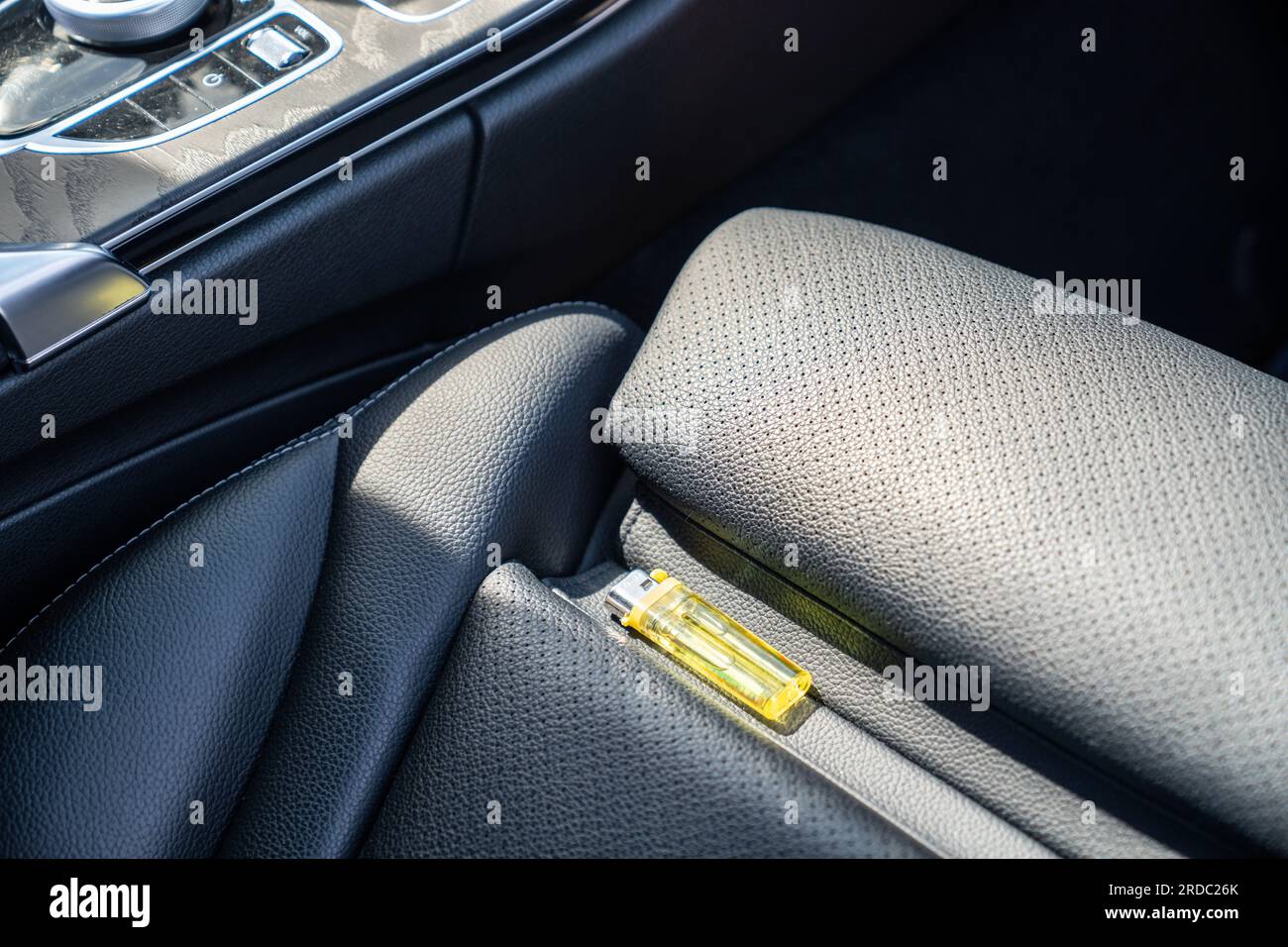 Lighter in car on hot sunny day. High temperatures in summer can cause