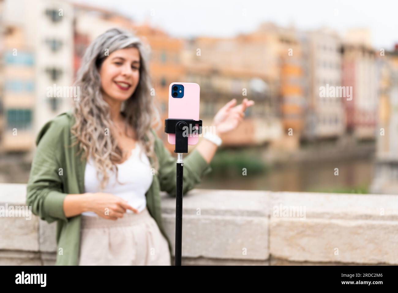 Influencer woman records herself talking about the city where she is located Stock Photo
