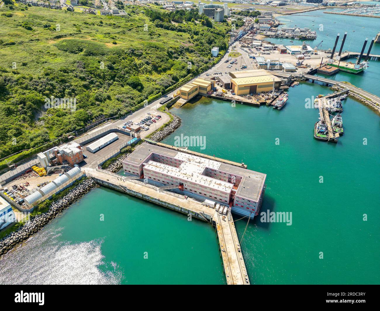 Portland, Dorset, UK.  20th July 2023.  Aerial view of the accommodation barge the Bibby Stockholm at its dock at Portland Port near Weymouth in Dorset, where it will house up to 500 asylum seekers for the next 18 months.  It arrived on Tuesday morning and is being prepared to receive the first asylum seekers which are due to arrive next week.  Picture Credit: Graham Hunt/Alamy Live News Stock Photo