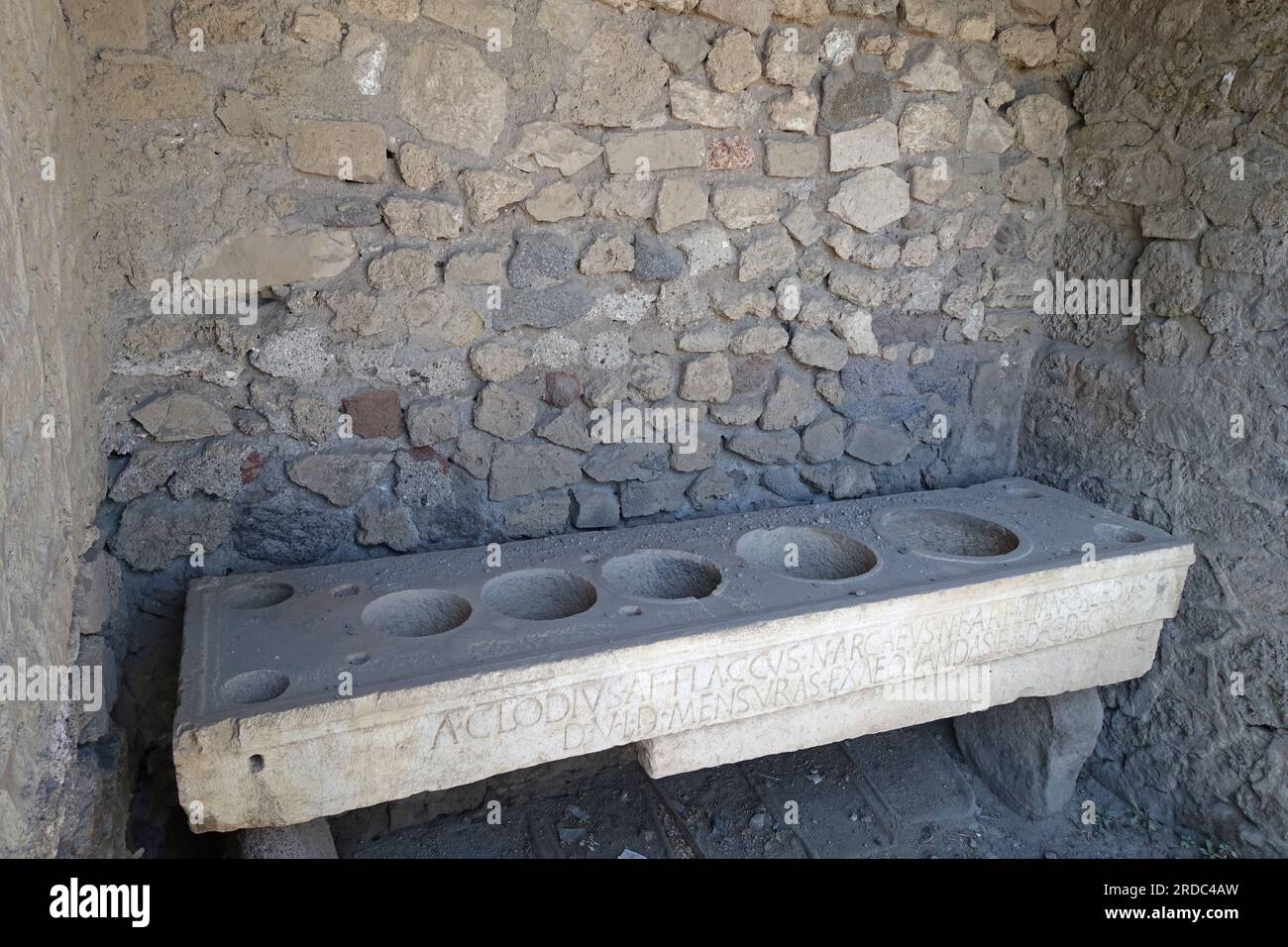 Pompey, Italy, ruins after excavation under ash after volcanic eruption in 79AD. Grocers showing measuring pots shown here, Stock Photo