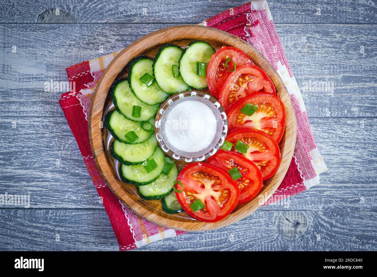 Round Wooden Dish With Sliced Vegetable Salad. Portion Of Salt In ...