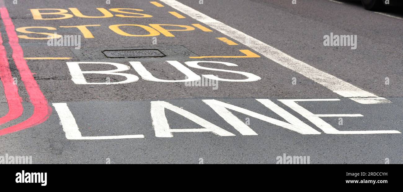 Road markings painted on a street warning car drivers of a bus lane Stock Photo