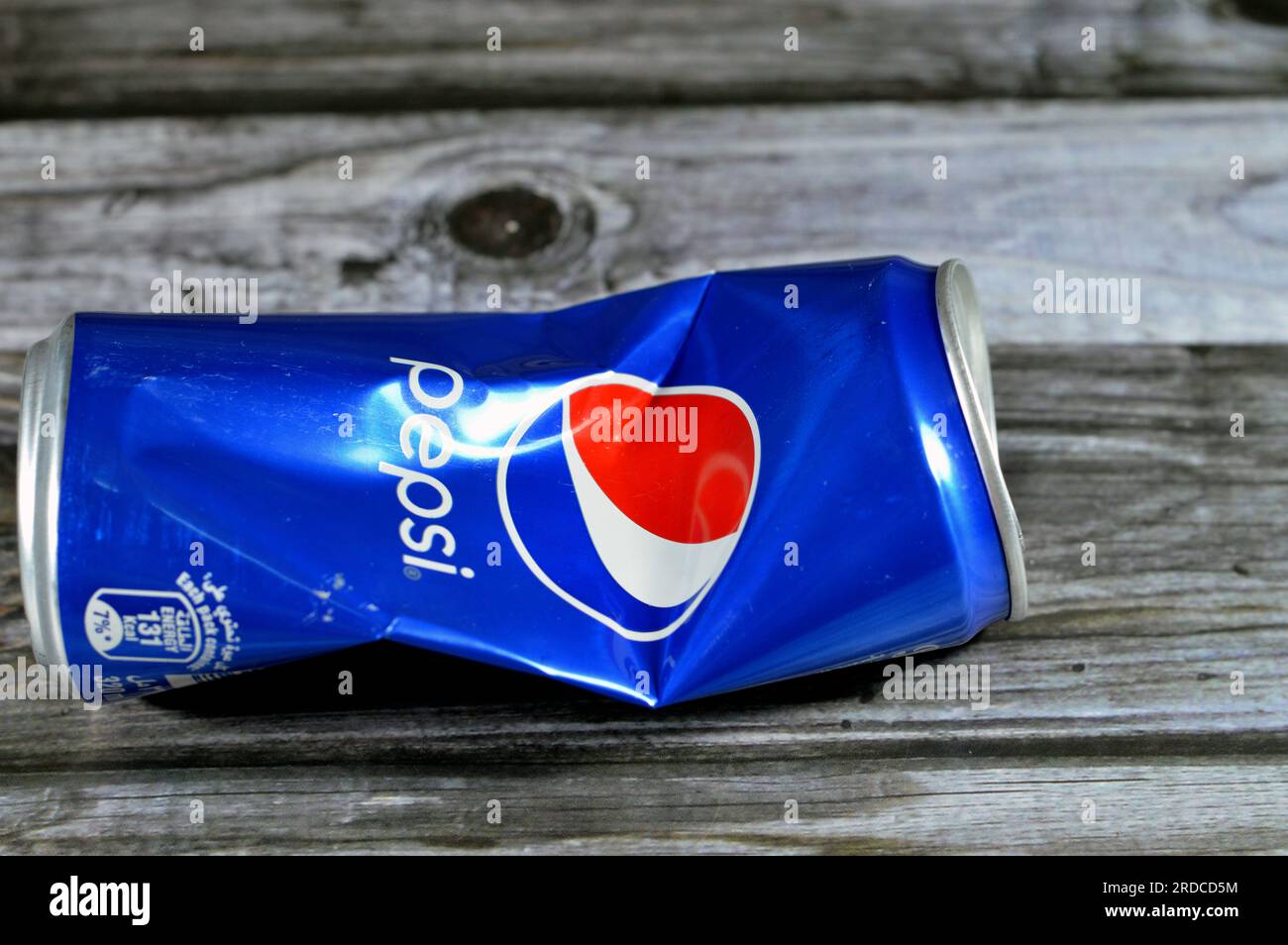 Cairo, Egypt, June 24 2023: Crushed Pepsi can, Cola flavor plastic bottle, a carbonated soft drink manufactured by PepsiCo. Originally created and dev Stock Photo