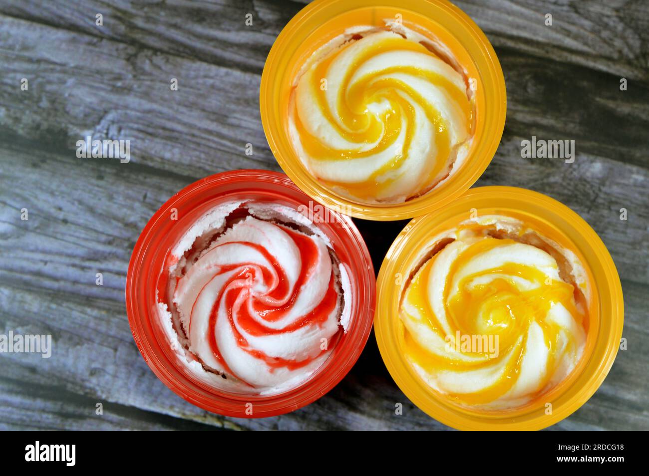 Mango and strawberry sauce ice cream frozen vanilla with fruit sauce