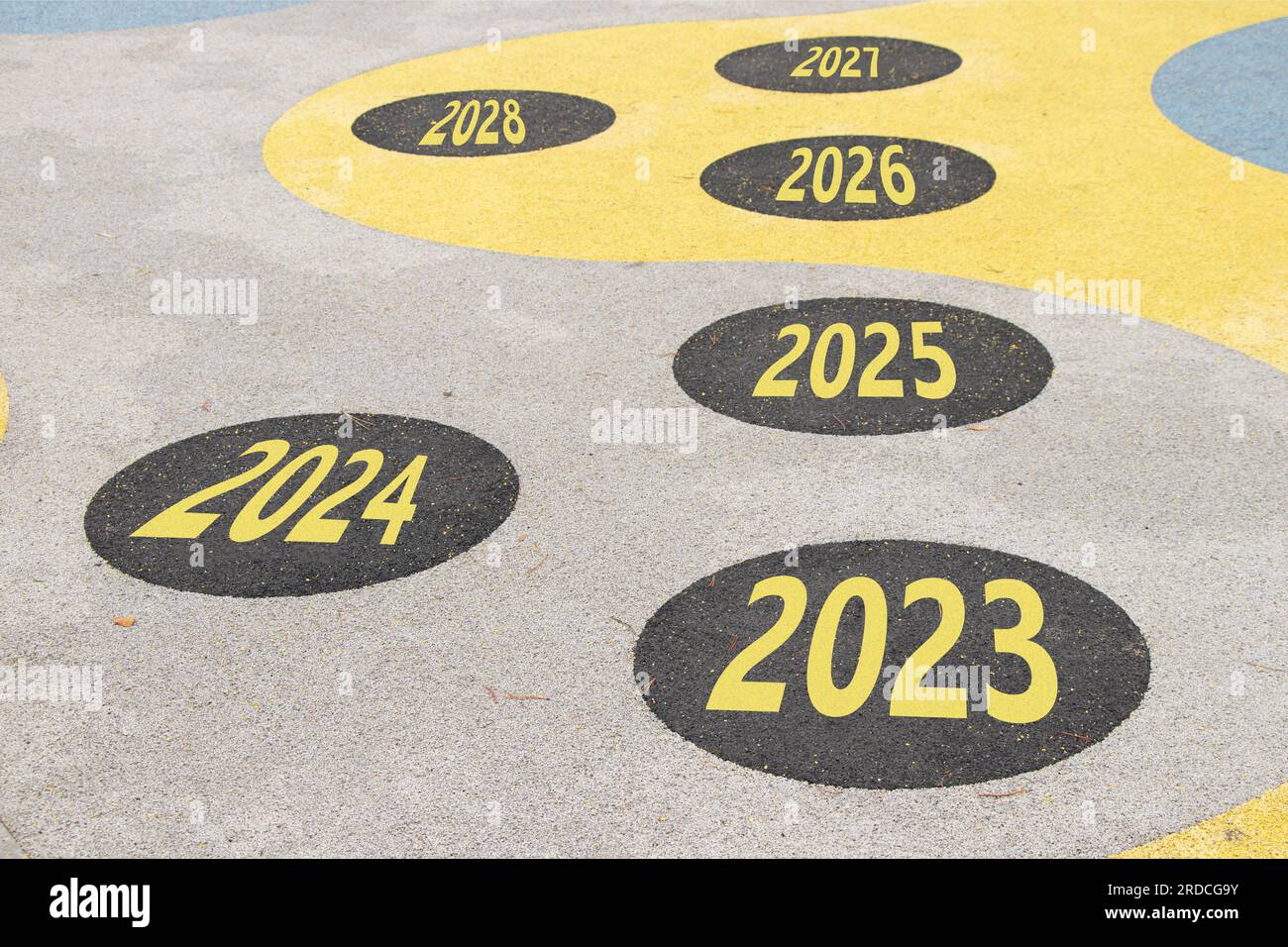 The years from 2023 to 2028 are written on the road in circles on the playground on the floor in Ukraine, achievements and successes in the new year, Stock Photo