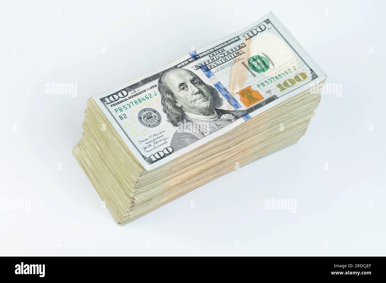100 american dollar bill pile isolated on white studio background Stock Photo