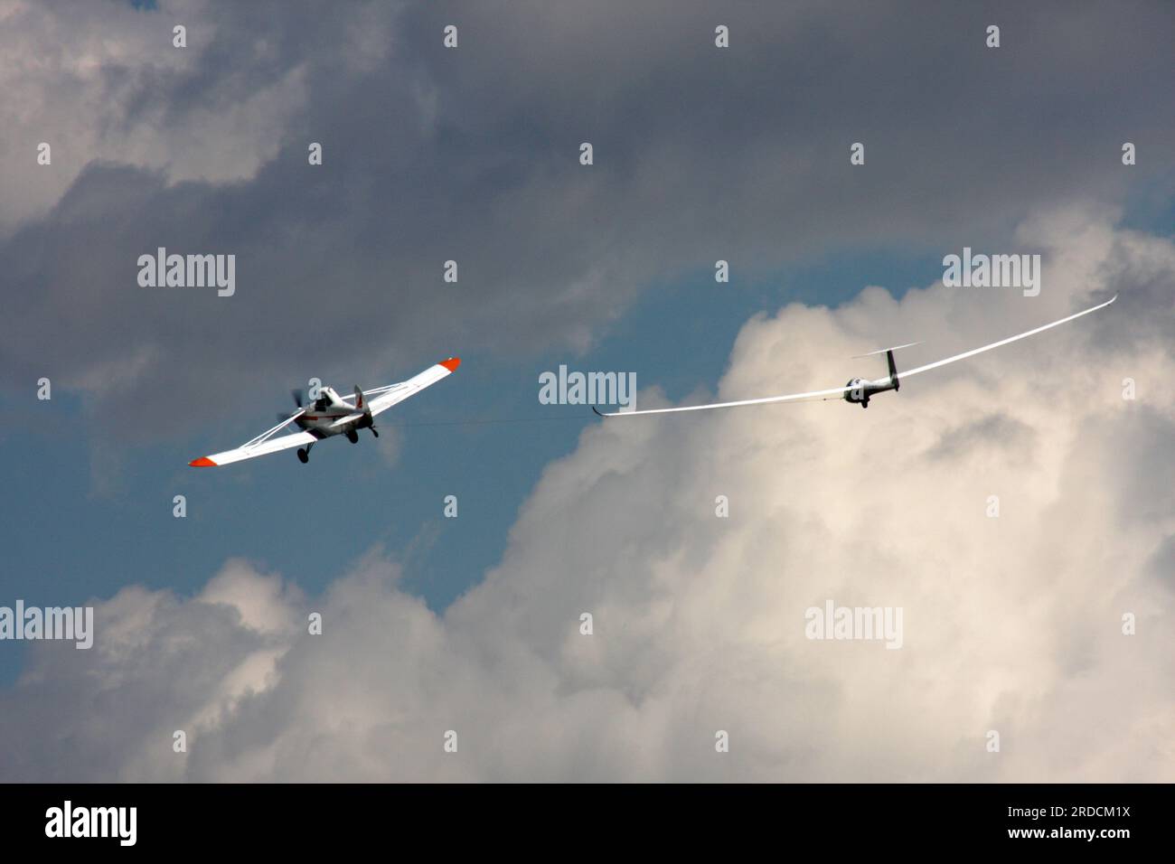 A glider being towed into the sky by a Piper Pawnee glider tug at a private airfield in West Sussex Stock Photo