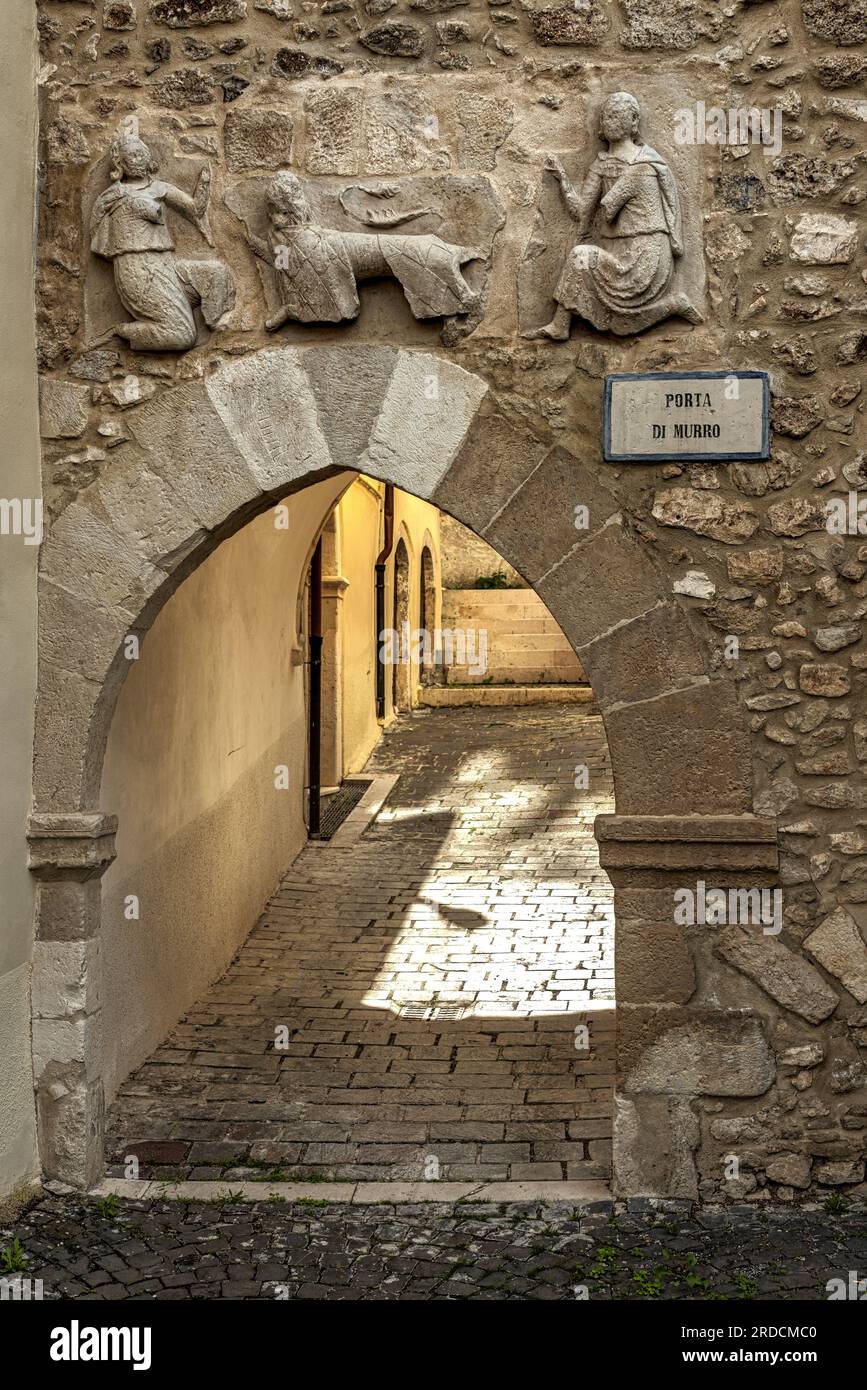 Porta di Murro is the last remaining gate of the walls of the town of Goriano Sicoli. Above the arch is a bas-relief with a lion and two female figure. Stock Photo