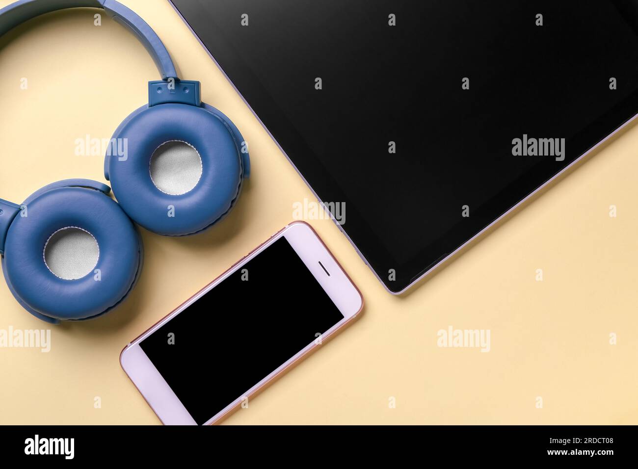 Modern gadgets on yellow background, closeup Stock Photo