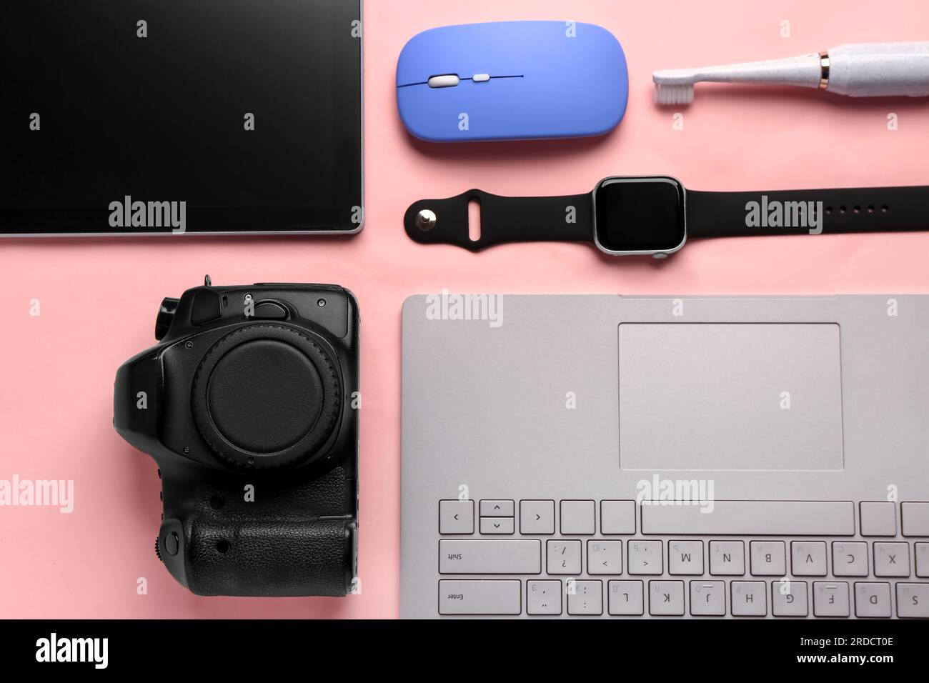 Modern gadgets on pink background Stock Photo