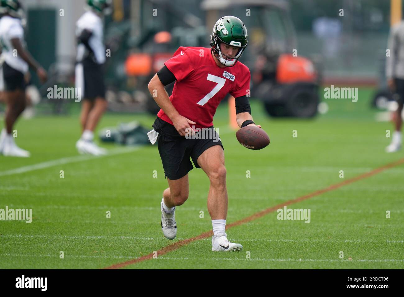 New York Jets quarterbacks Tim Boyle, left, Chris Streveler, center, and  Zach Wilson, right, watch as Aaron Rodgers participates in a drill at the  NFL football team's training facility in Florham Park