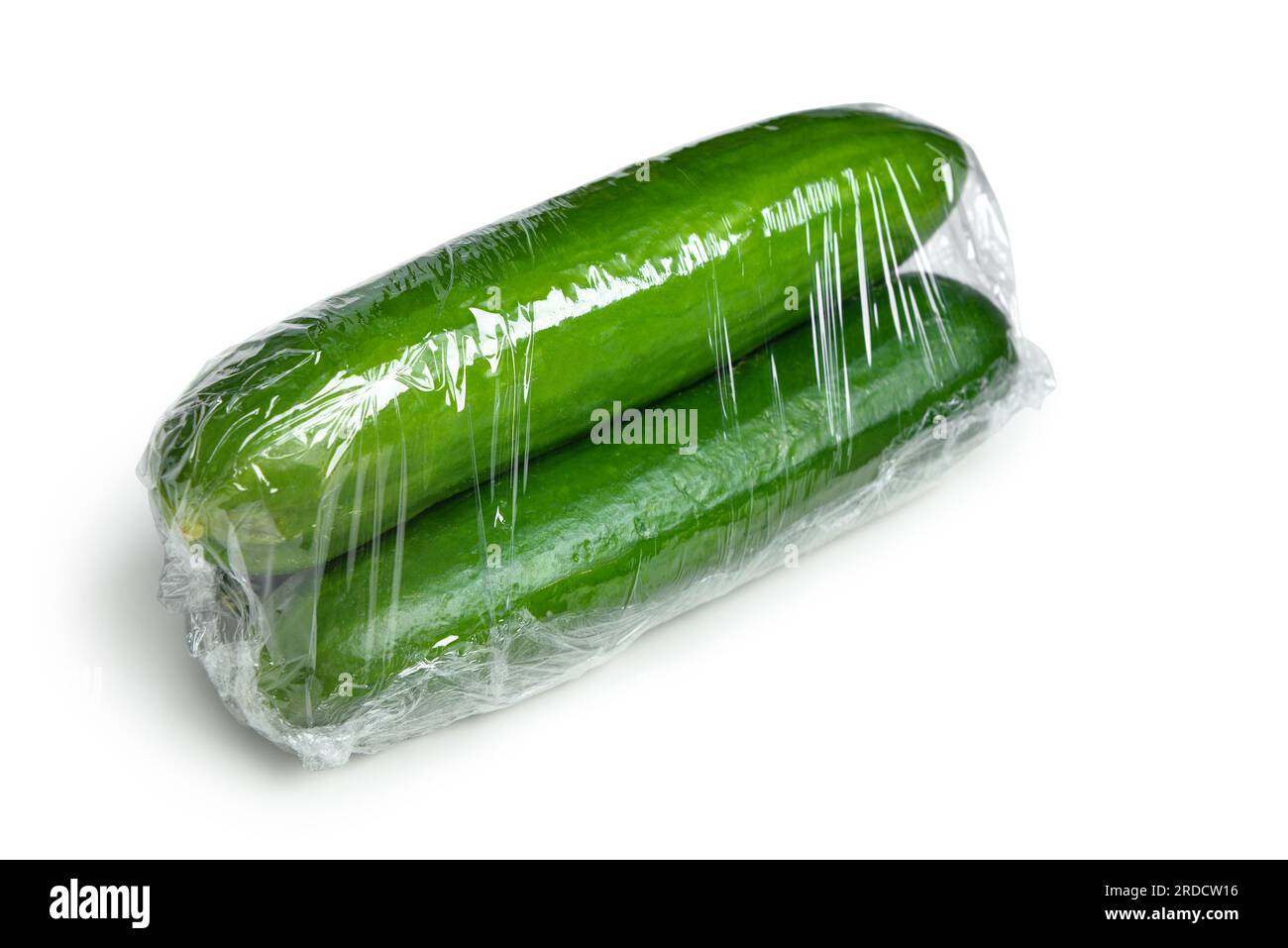 Cucumber in plastic food wrap on white background Stock Photo Alamy