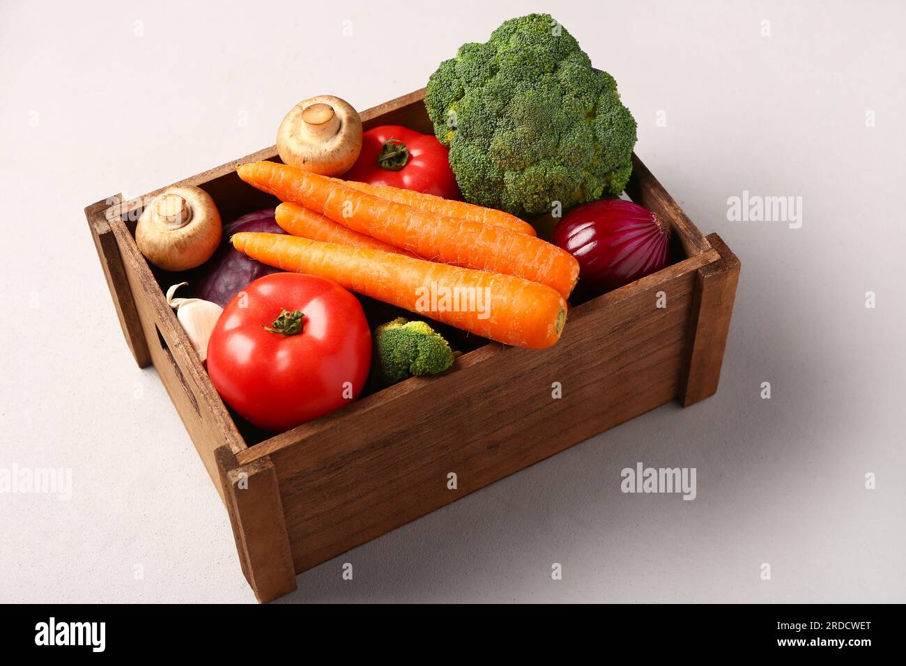 Wooden box with different fresh vegetables on white background Stock ...
