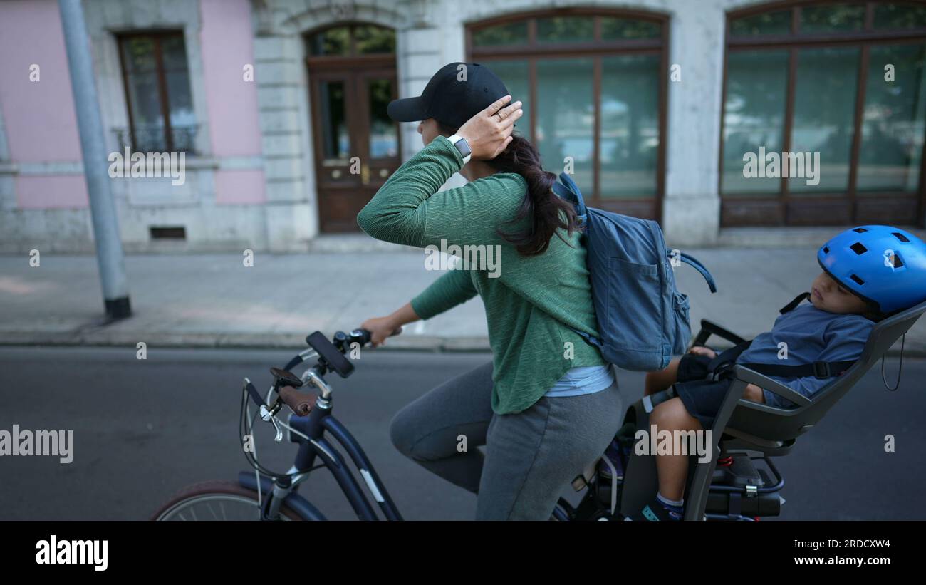 Lady riding bike with baby in bag hotsell