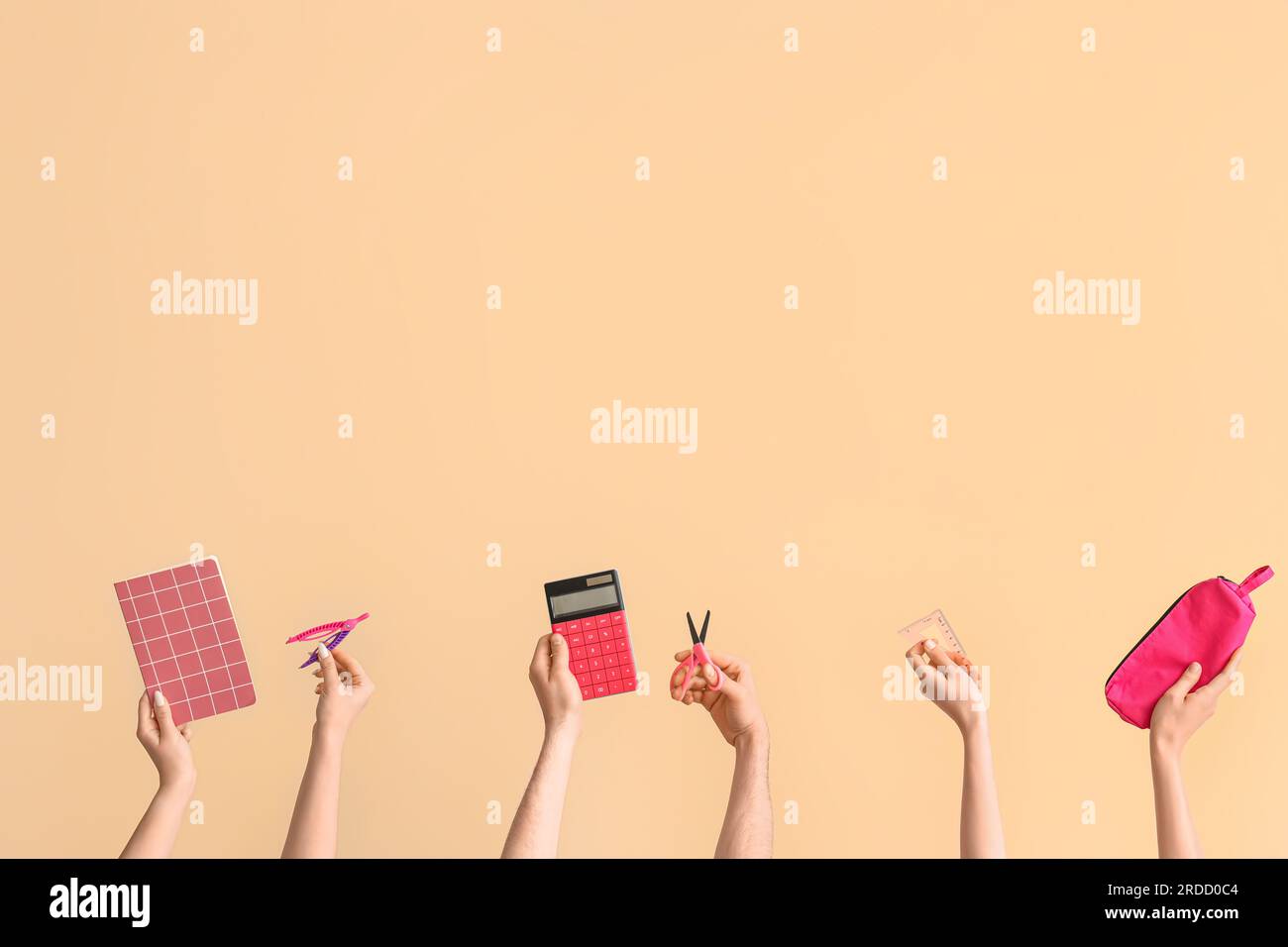 Hands with school supplies on beige background Stock Photo - Alamy