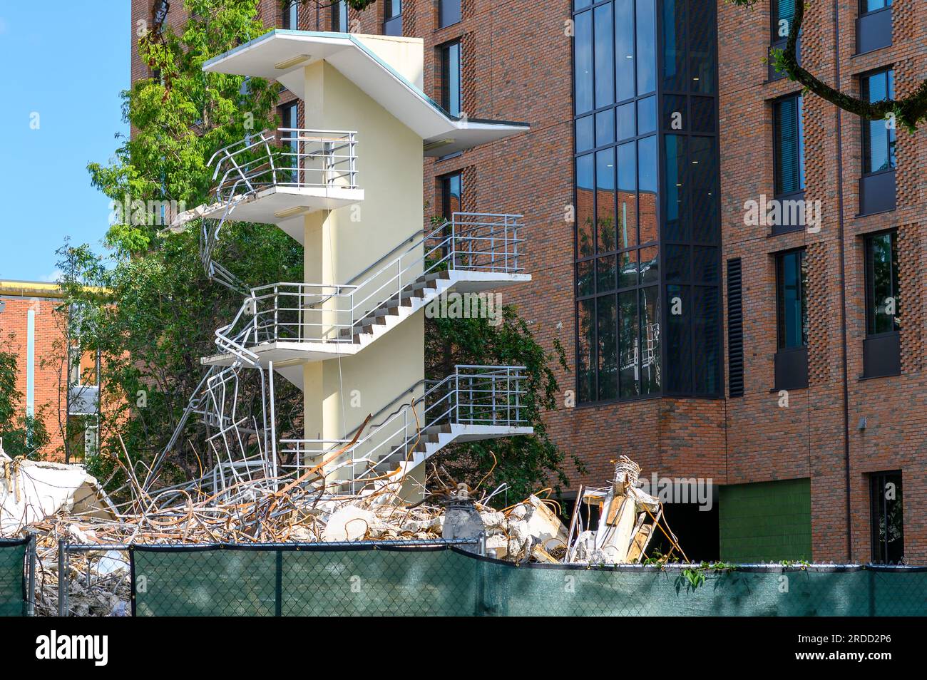 NEW ORLEANS, LA, USA - JULY 19, 2023: Staircase left standing after old dormitory demolition with a new dorm in the background at Tulane University Stock Photo