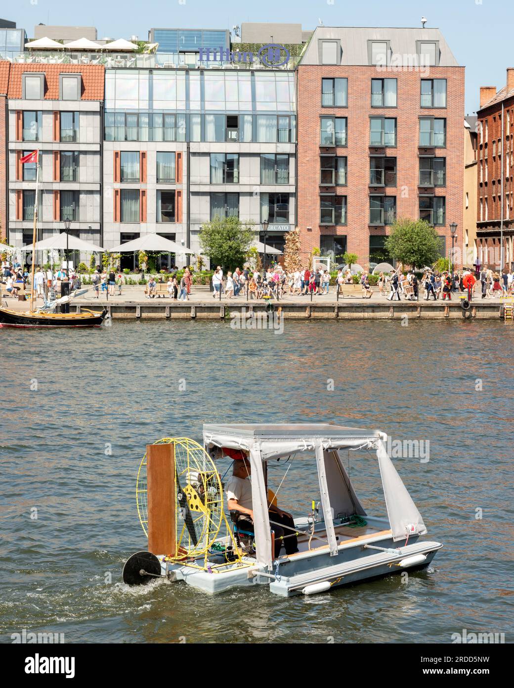 Funny DIY made up small vessel on Motlawa river in the Old Town of Gdansk, Poland Stock Photo