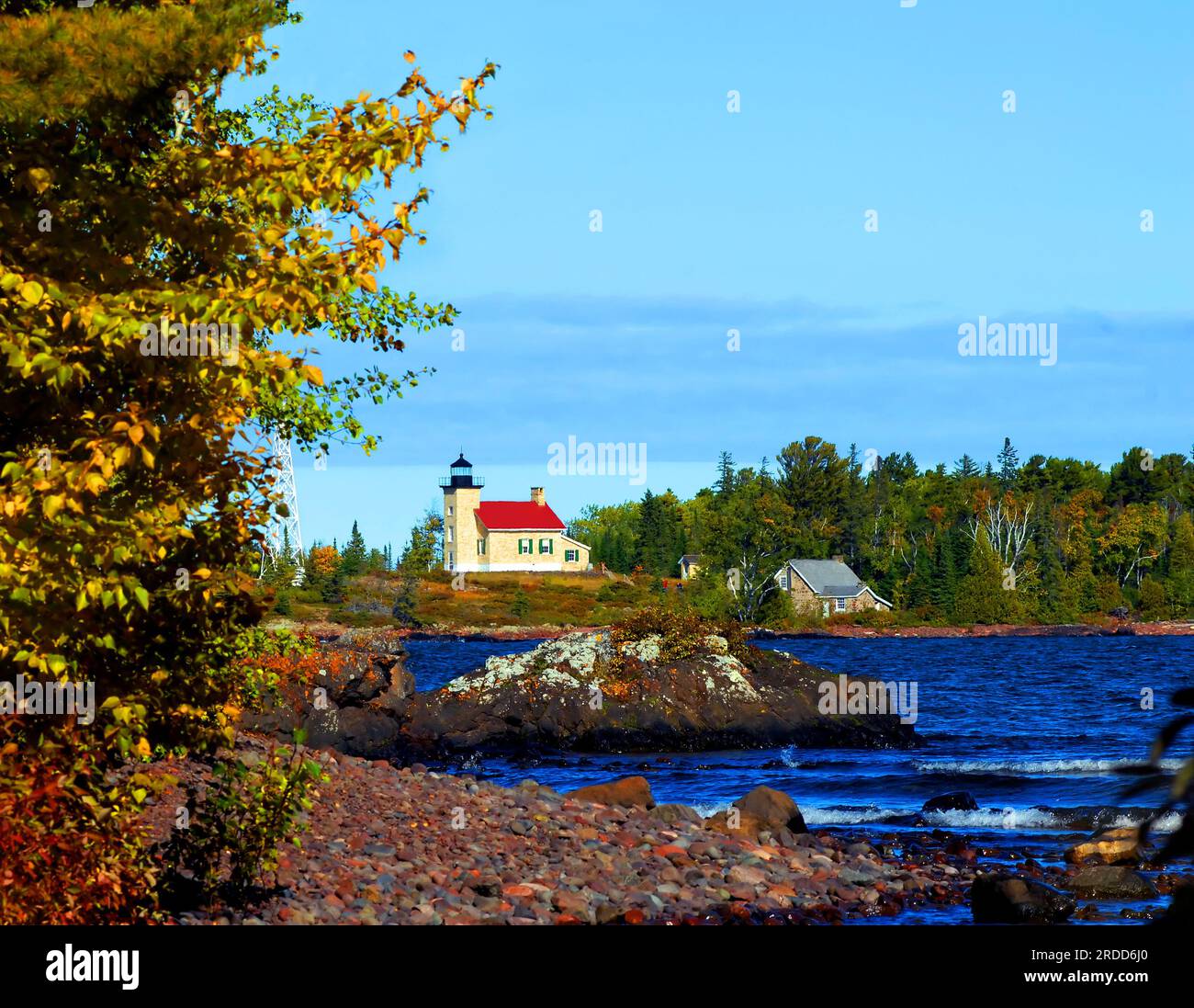 Copper Harbor Lighthouse sits at the tip of the Keweenaw Peninsula in Upper Peninsula, Michigan.  Visitors can be seen walking the steps to view the l Stock Photo