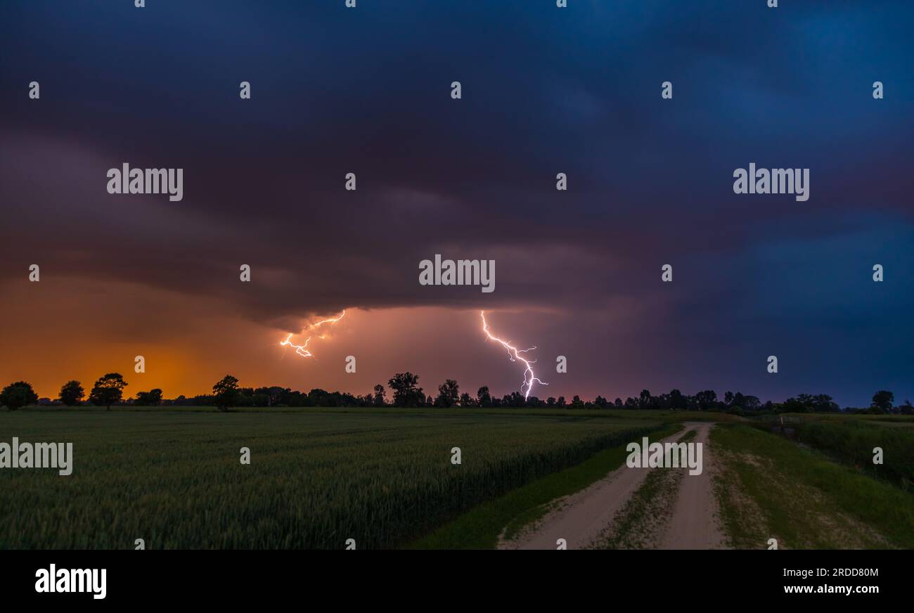 Storm over glade road in the middle of the fields. Spring season. Stegna, Zulawy, Pomerania, Poland. Stock Photo