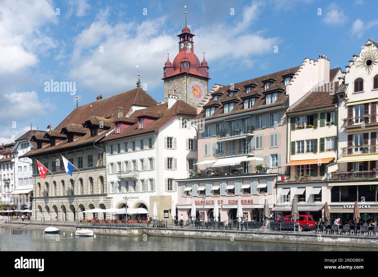 Town Hall Clock Tower and riverside buildings from The Kapellbrücke (Chapel Bridge), City of Lucerne (Luzern), Lucerne, Switzerland Stock Photo