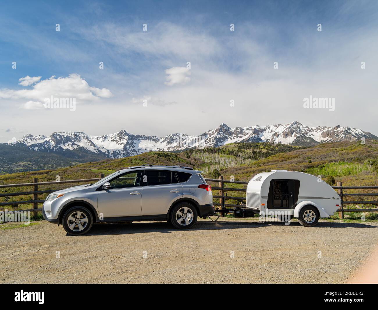 Sunny view of the landscape of Mt Sneffels with a vehicle towing travel ...