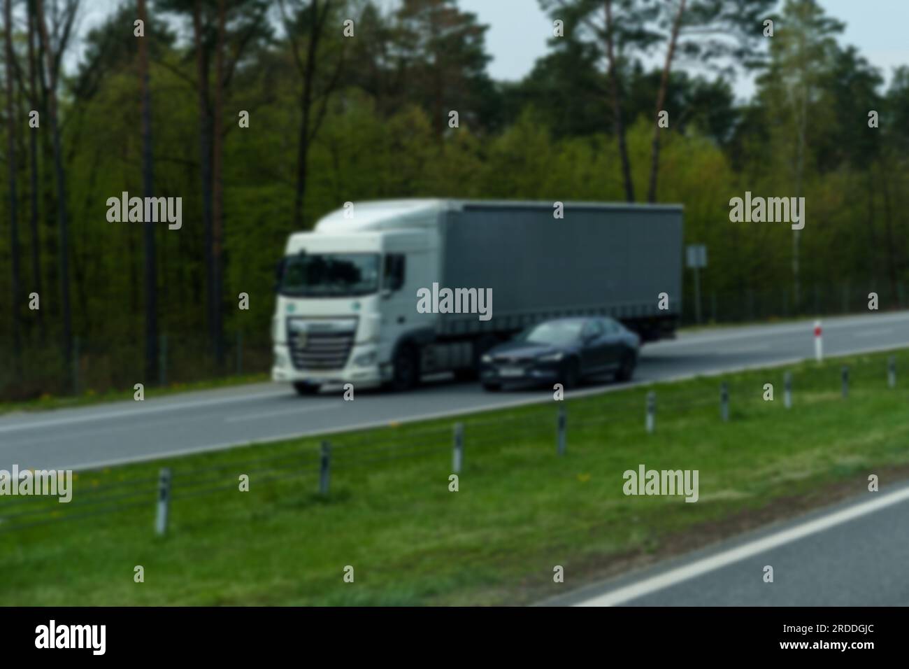 Wilczy Las, Poland - April 24, 2023: The movement of cargo transport transporting goods in tilt semi-trailers. Stock Photo