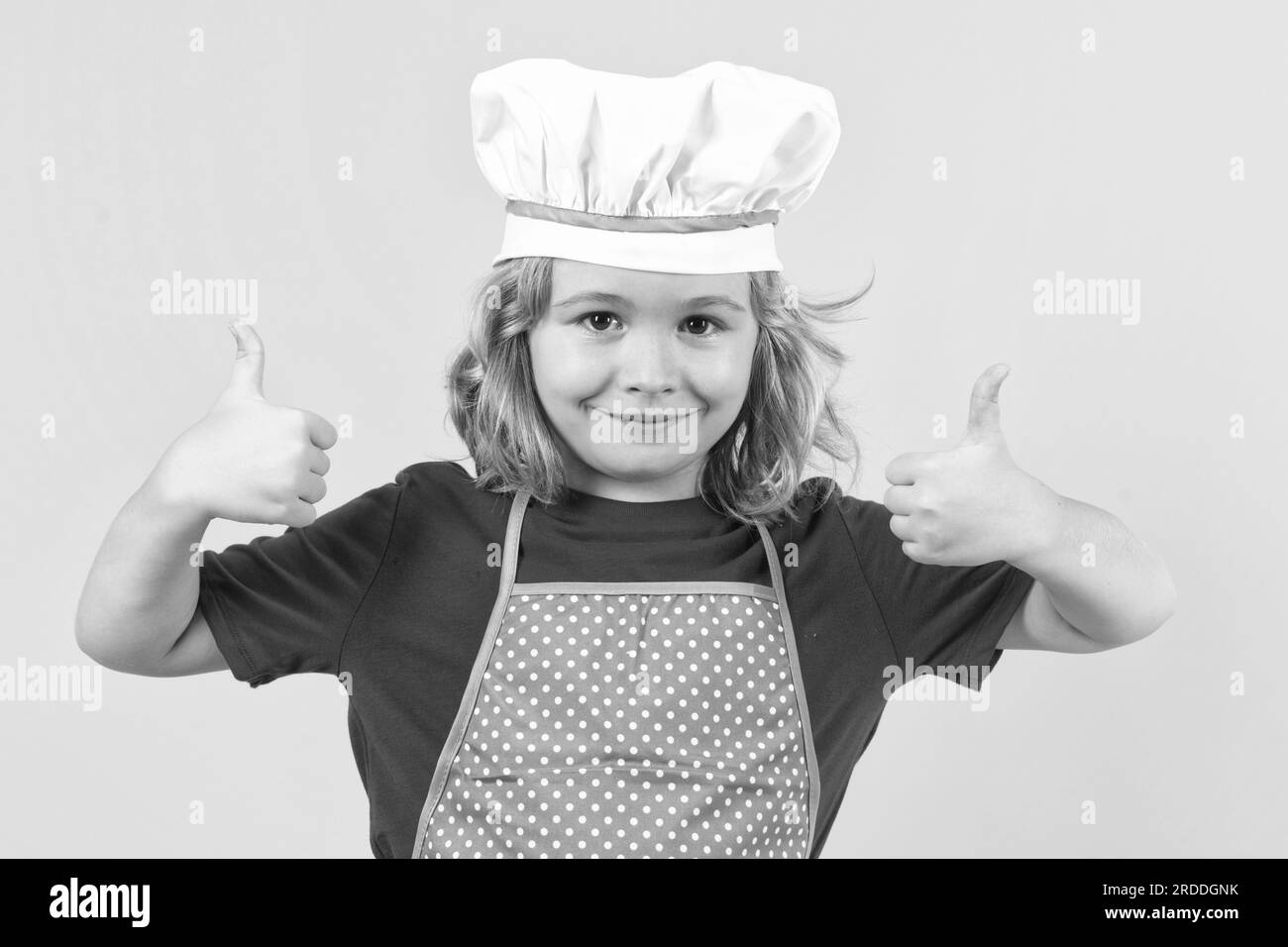 Kid chef cook, studio portrait. Children cooking. Kid boy with apron