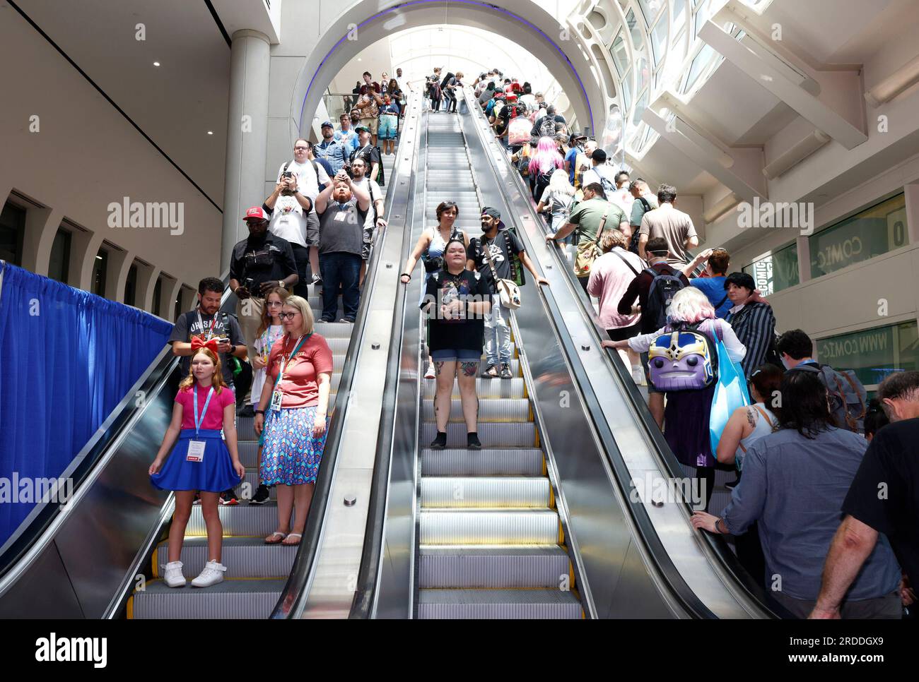 Guests ride the escalators at Comic-Con International on Thursday, July ...
