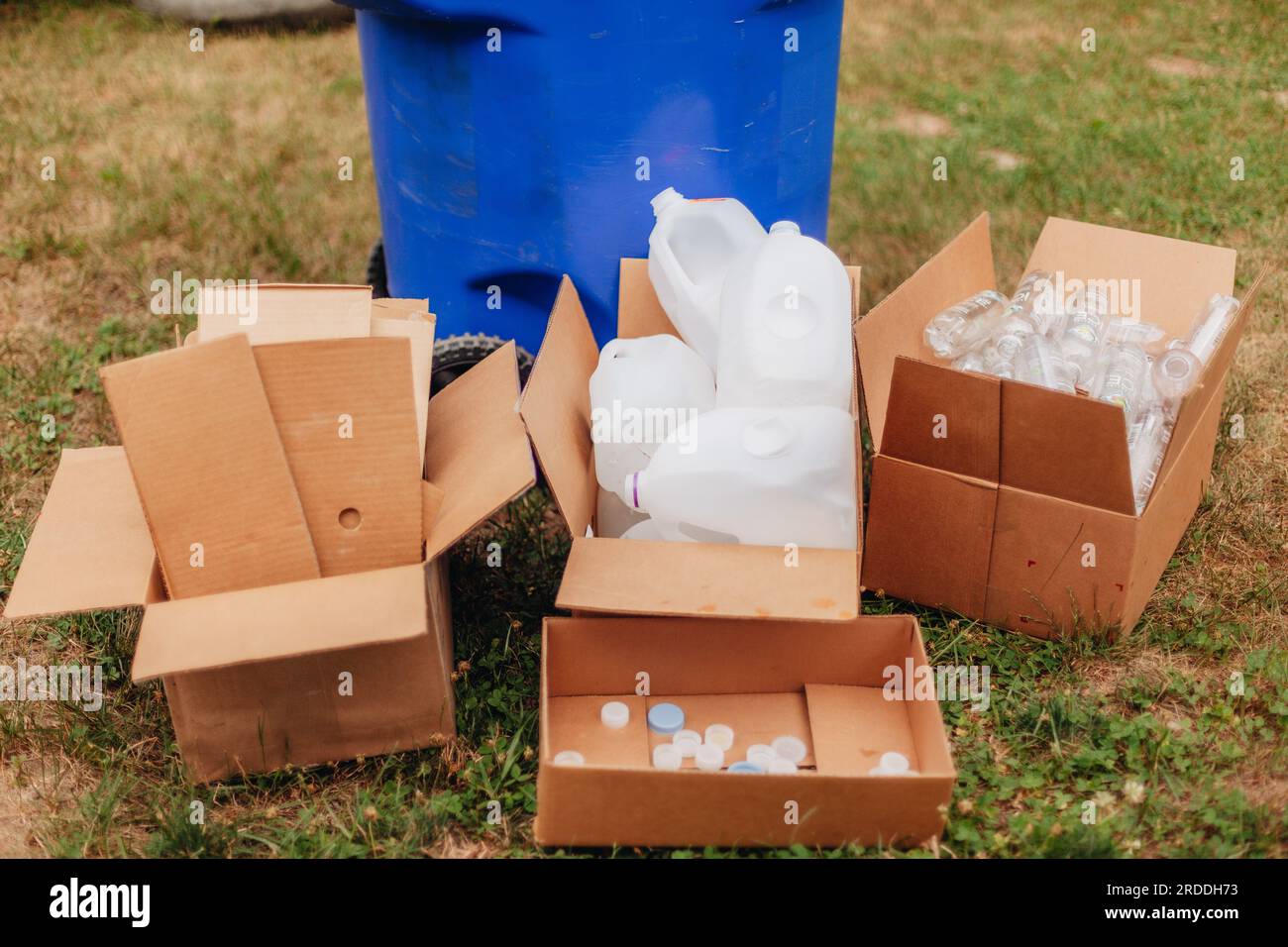 Recycling and environmentally friendly, bottle caps in card board box among plastic bottles