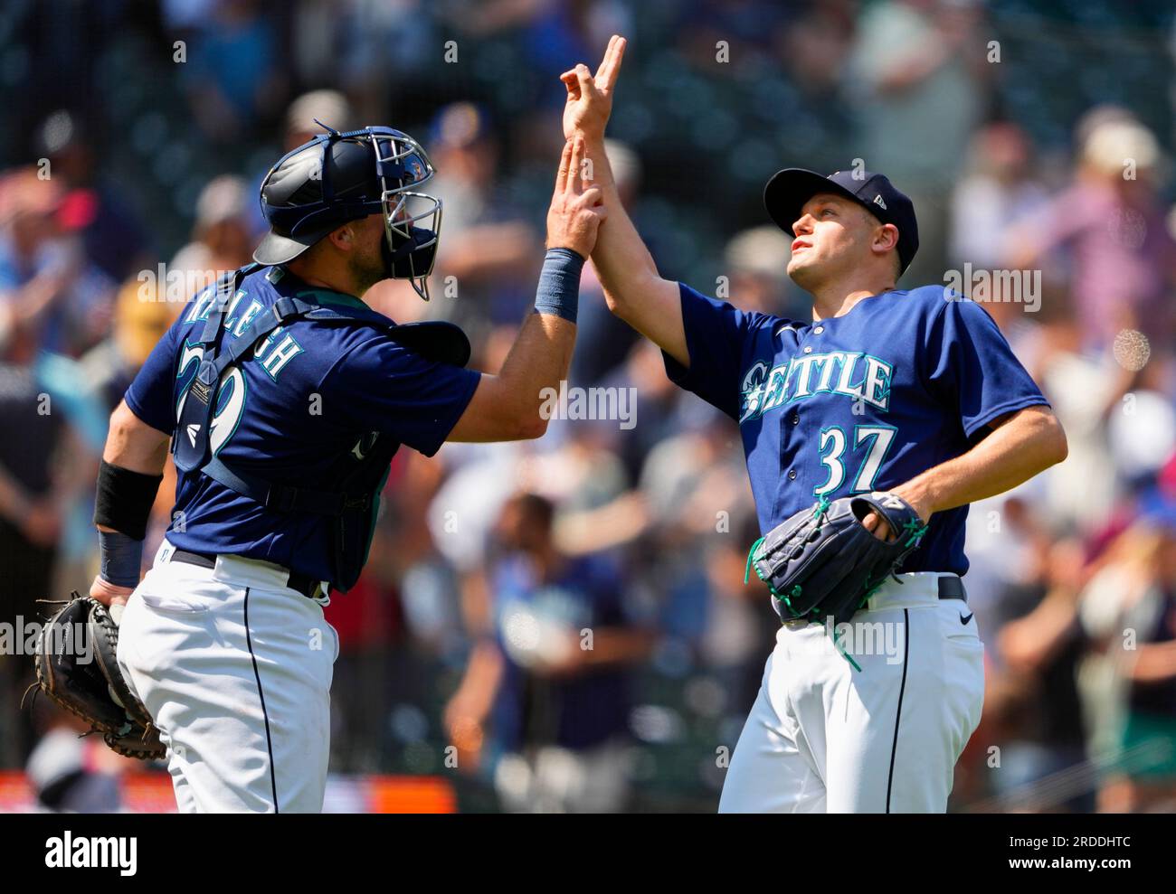 Seattle Mariners catcher Cal Raleigh (29) greets relief pitcher Paul