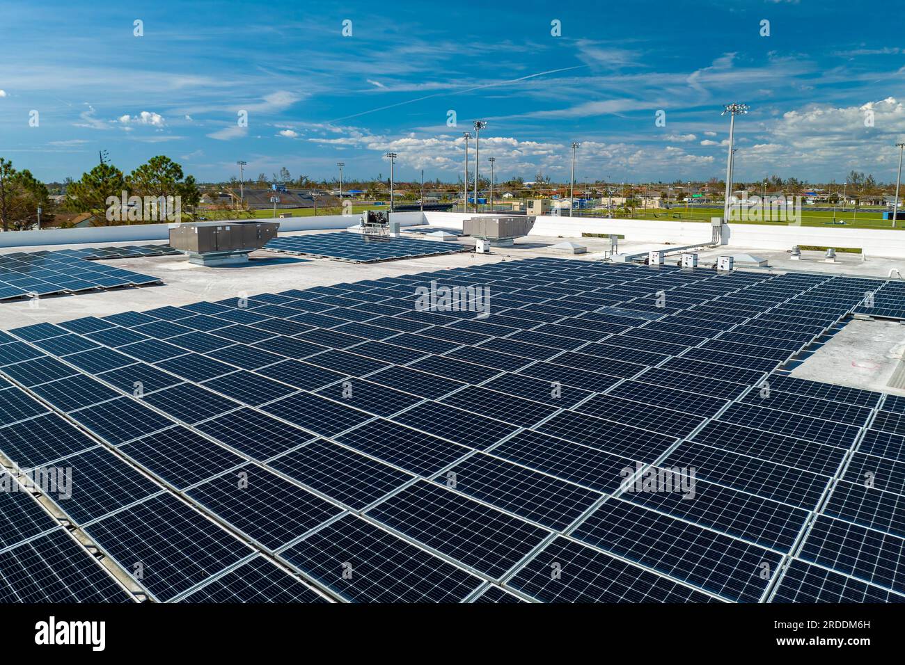 Aerial view of blue photovoltaic solar panels mounted on industrial ...
