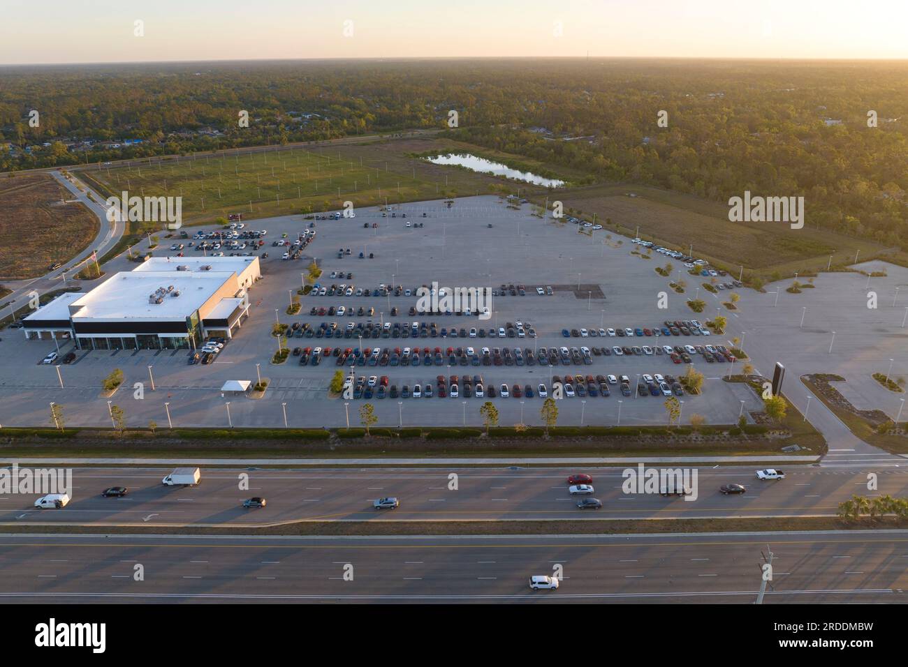 Aerial view of dealership parking lot with many brand new cars for sale