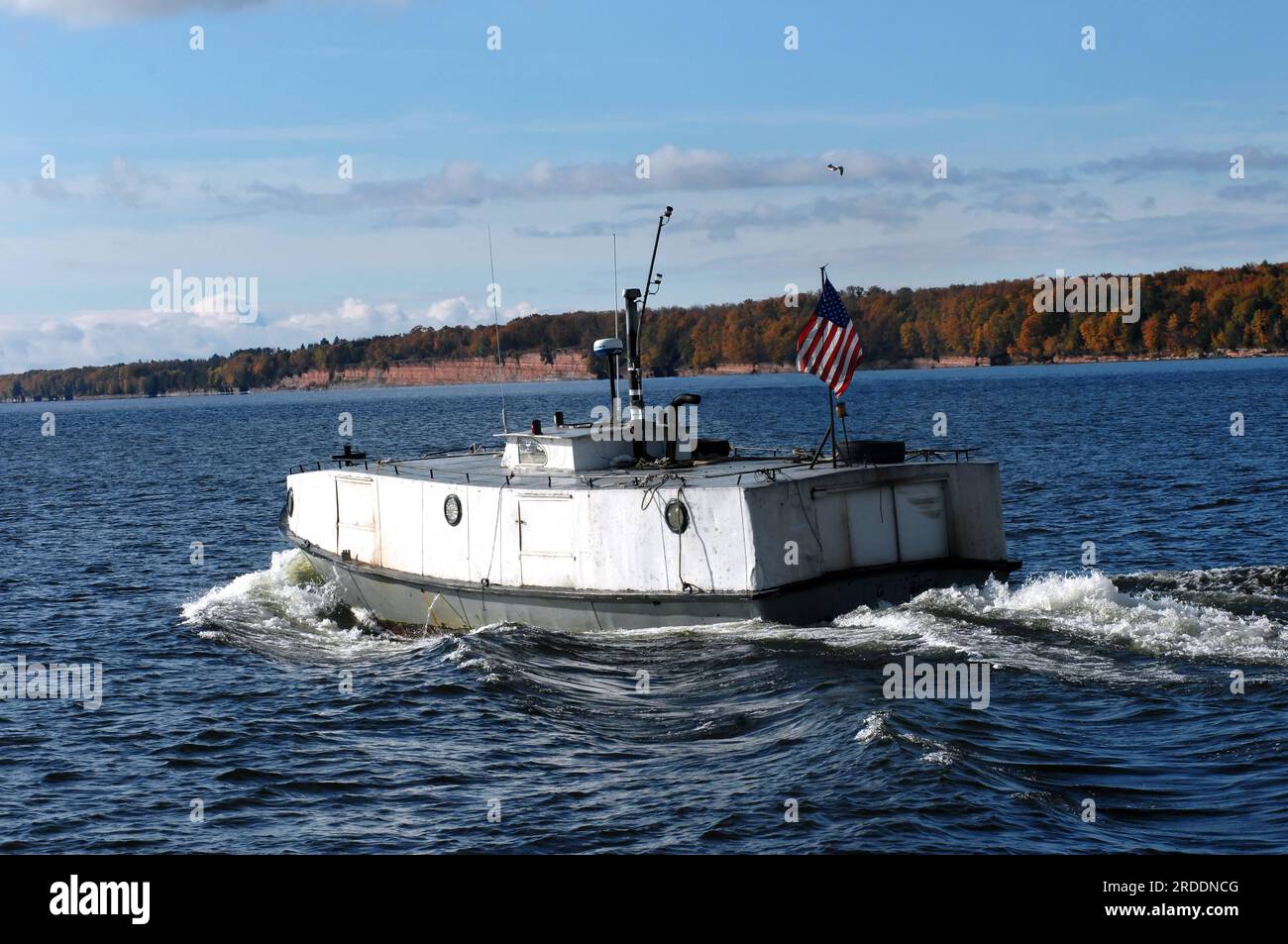 Rustic fishing vessel, locally dubbed the Finish Submarine, motors across the choppy waters of Lake Superior near the South entry of the Portage Canal Stock Photo