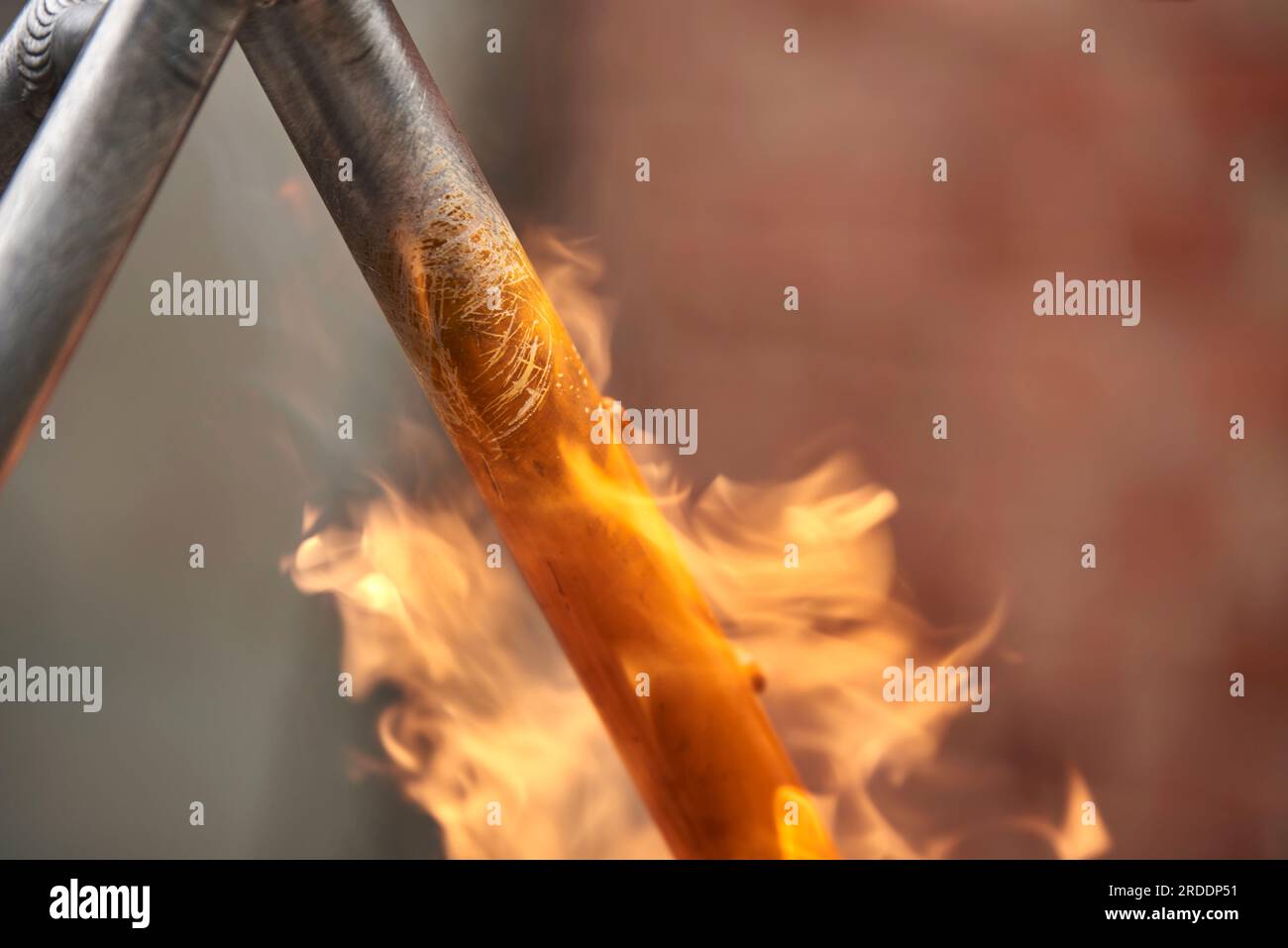 Manual bicycle renovation work, paint removal process using a torch