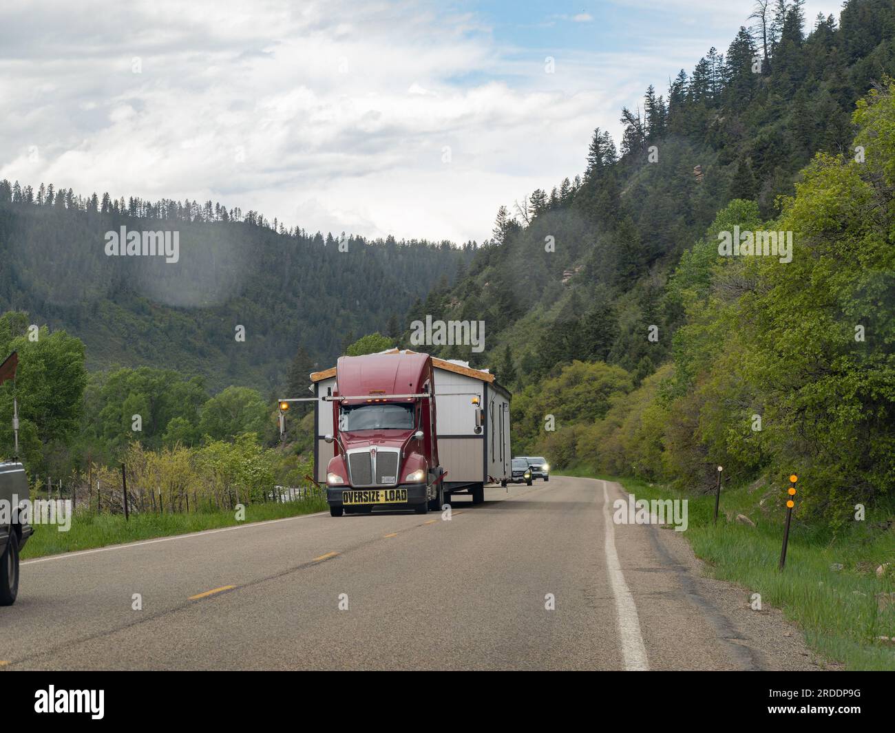 Colorado, JUN 7, 2023 - Big truck is loading with a tiny home on the road Stock Photo