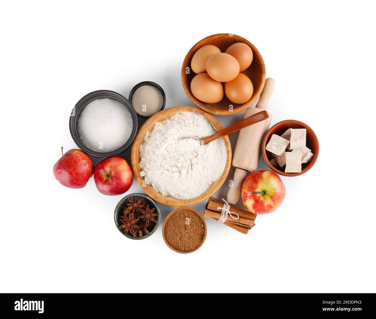 Flour, yeast cake and different ingredients on white background, top